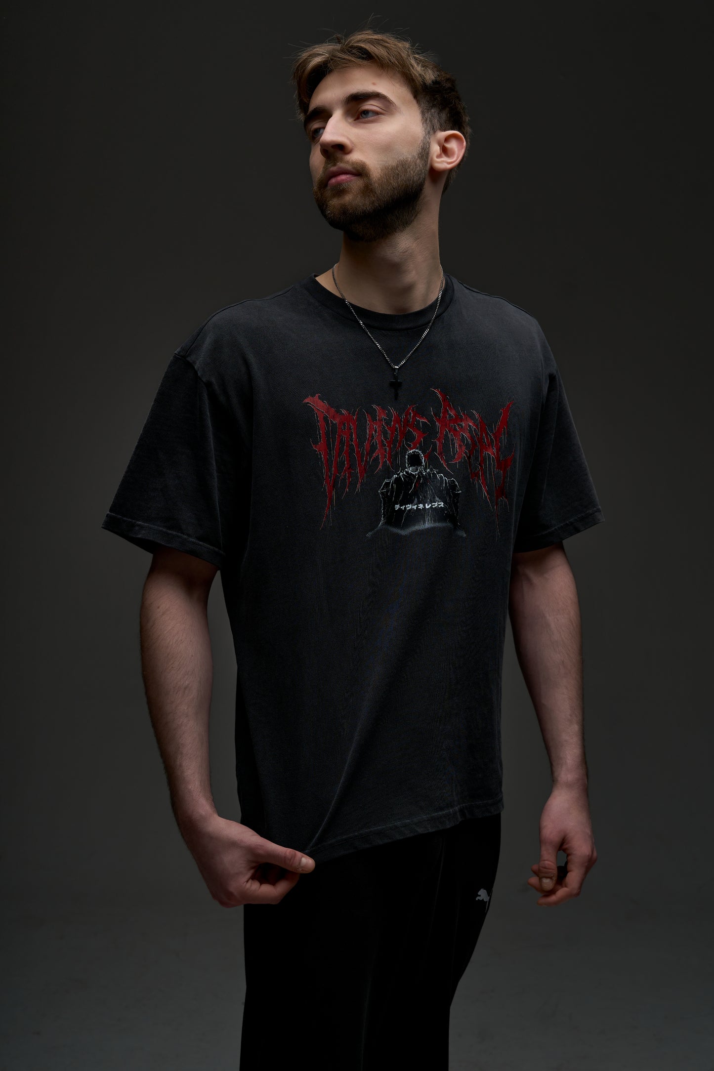 Model wearing the washed black Guts Dark Edition tee - front view with red Divine Reps chest logo