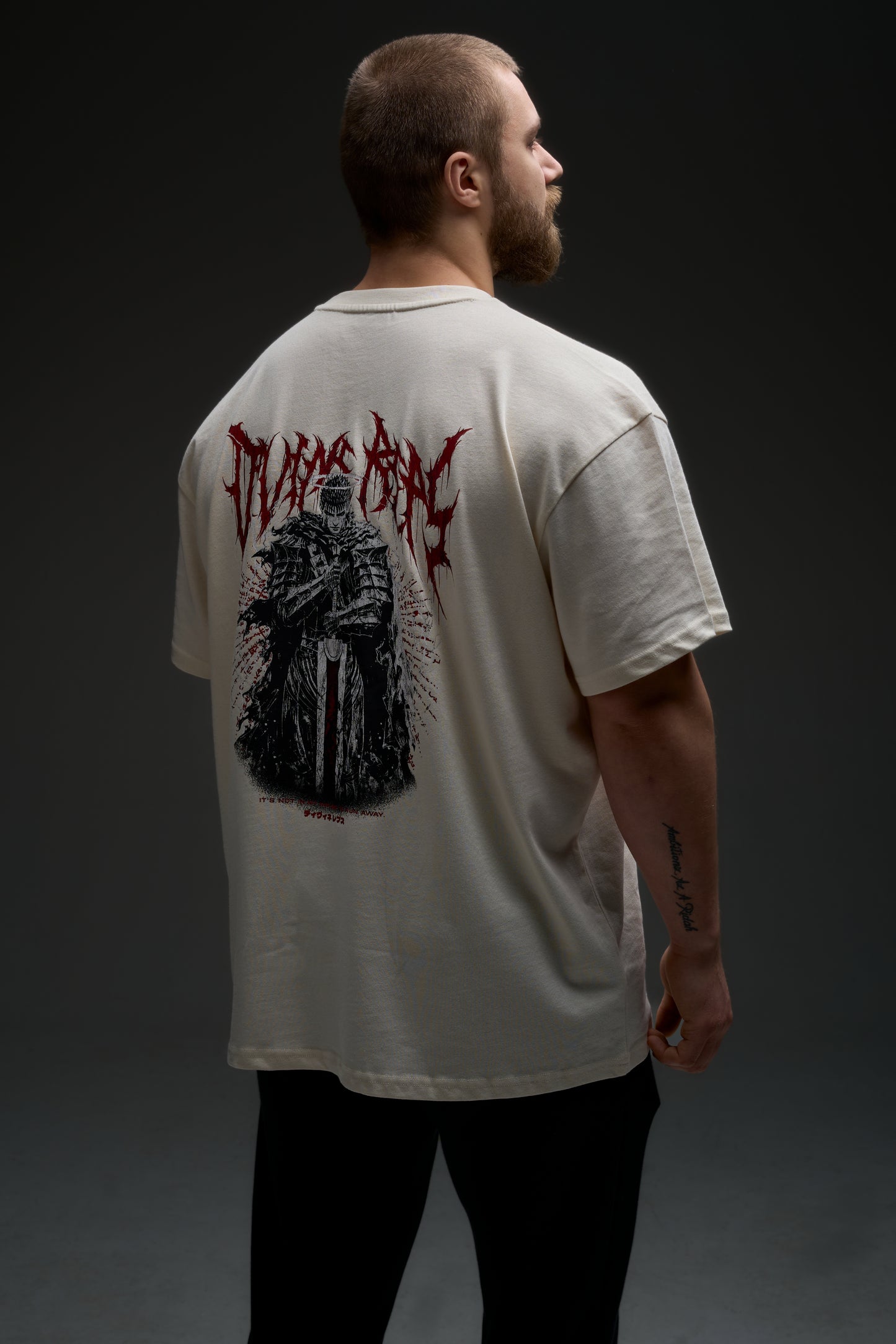 Model wearing the natural raw Guts armor tee - back view with large armored warrior print