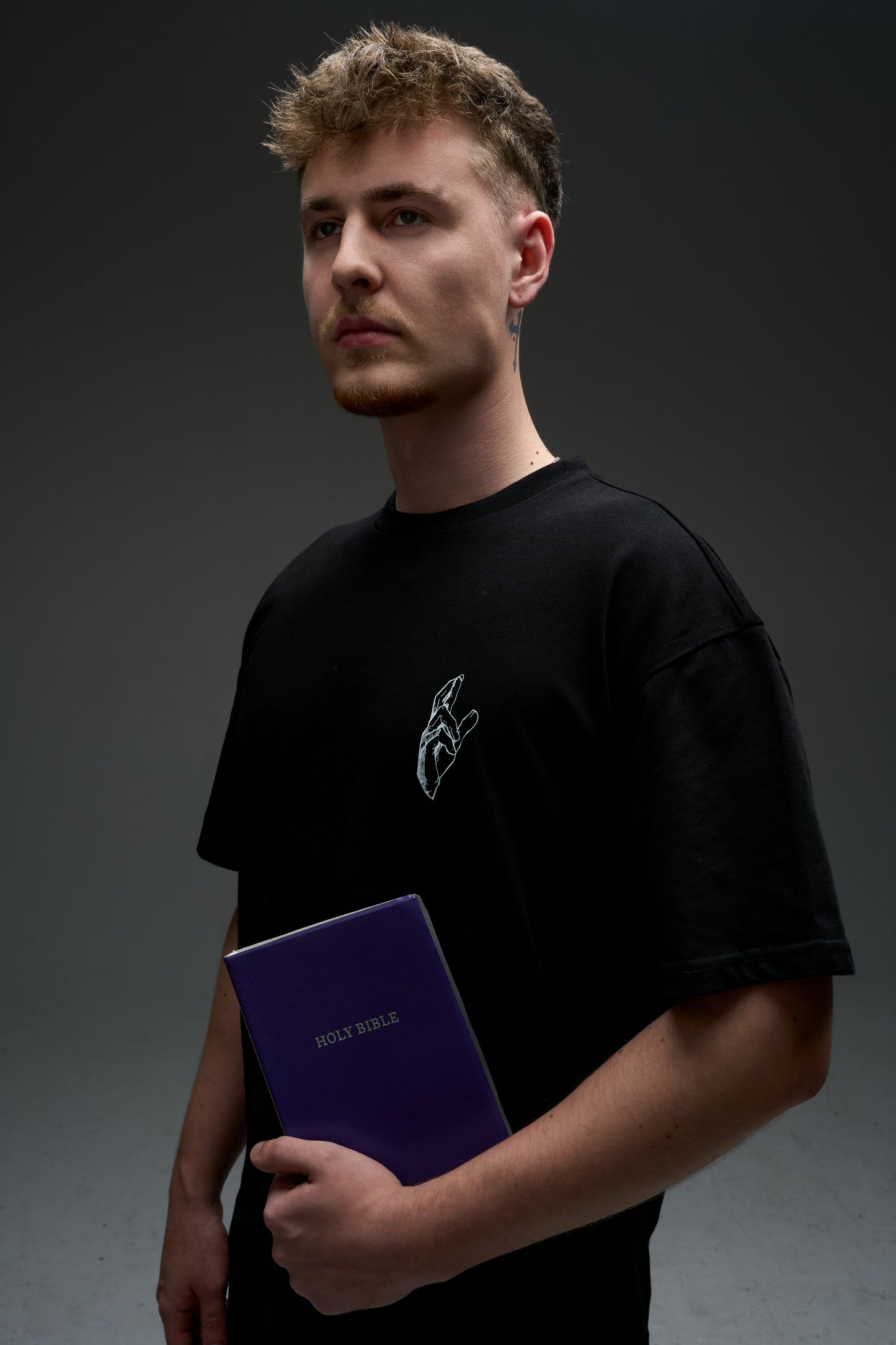 Model wearing the black Gojo armor tee - front view with small chest print, oversized 240 GSM drop-shoulder fit